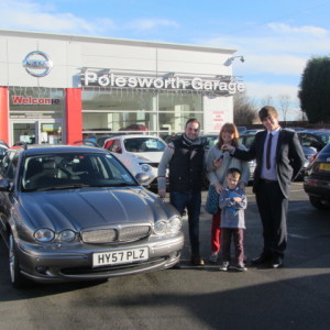 Rebecca Hughes and family collecting their Jaguar X Type from our Sales Executive Jon Taylor