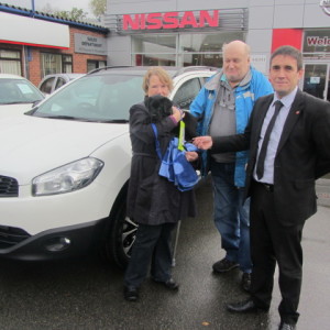 Mr & Mrs Booth & Hunter the Dog collecting their new Nissan Qashqai +2 from our Sales Executive Mark Bolton