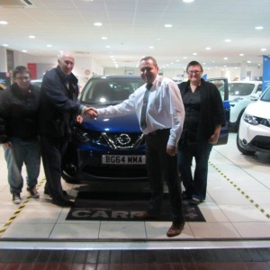 Mr Hinman and family collecting his New Nissan Qashqai from Our Sales Manager Steve Sadler