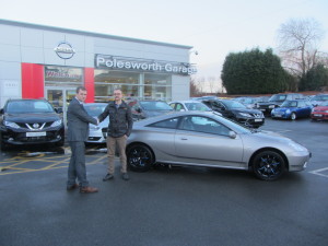 Our New Salesman Phil Tierney Handing Over His First Sale, A Toyota Celica To Local Customer Mr Luke Davies.