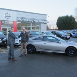 Our New Salesman Phil Tierney Handing Over His First Sale, A Toyota Celica To Local Customer Mr Luke Davies.