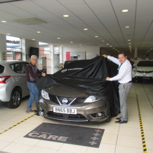 Sales Manager Steve Sadler Helping Mr Dolphin To Unveil His New Nissan Qashqai